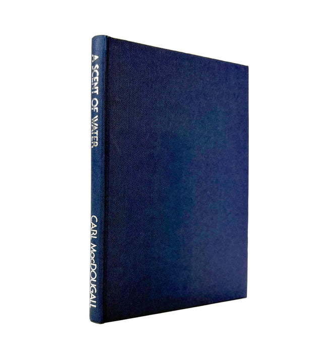 Blue book titled 'A Scent of Water' by Carl McDougall on a white background