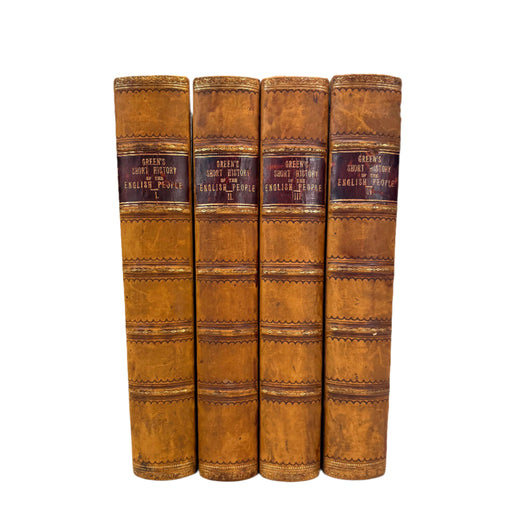 Set of four leather-bound books on a white background