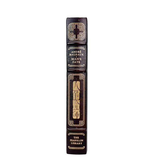 A close-up vertical shot of a book spine, showing the title 'The Franklin Library' by Andre Malleaux, with gold decorative lettering and borders on a dark brown leather-like background, set against a plain white background.