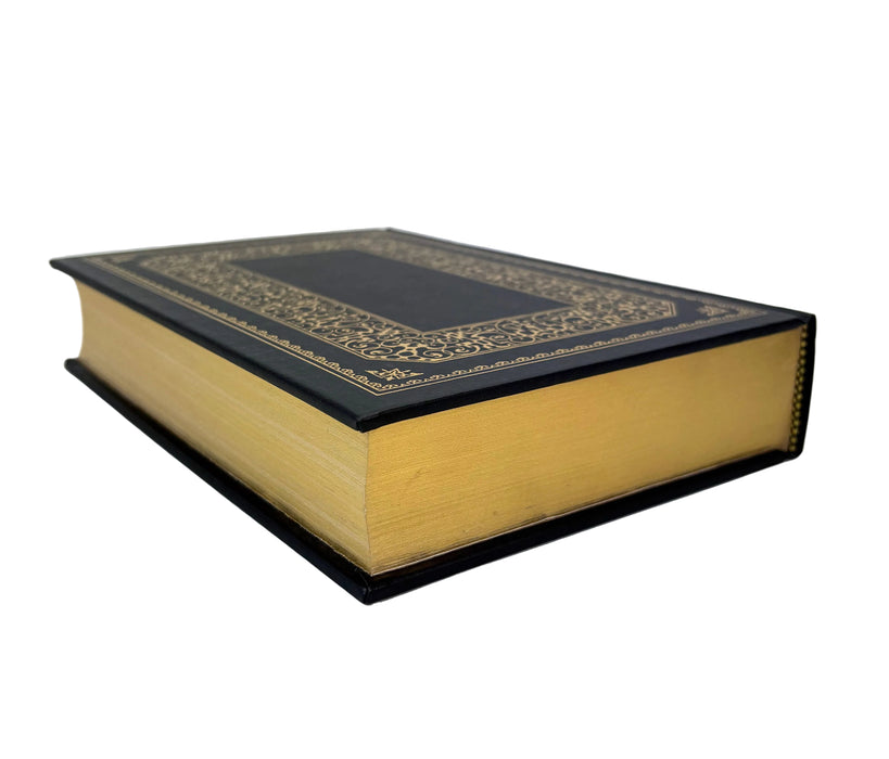 A hardcover book with a black leather-bound cover, gold ornamental border detailing on the front cover, and thick warm yellow-gold pages, shown on a plain white background.