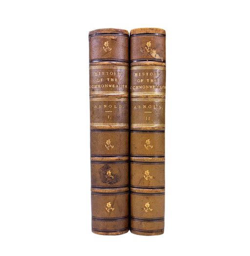 Two leather-bound books titled 'History of the Commonwealth' by Arnold on a white background