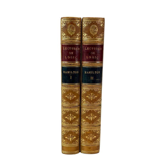 Two antique hardcover books, 'Lectures on Logic' by Hamilton, standing upright side-by-side against a plain white background.