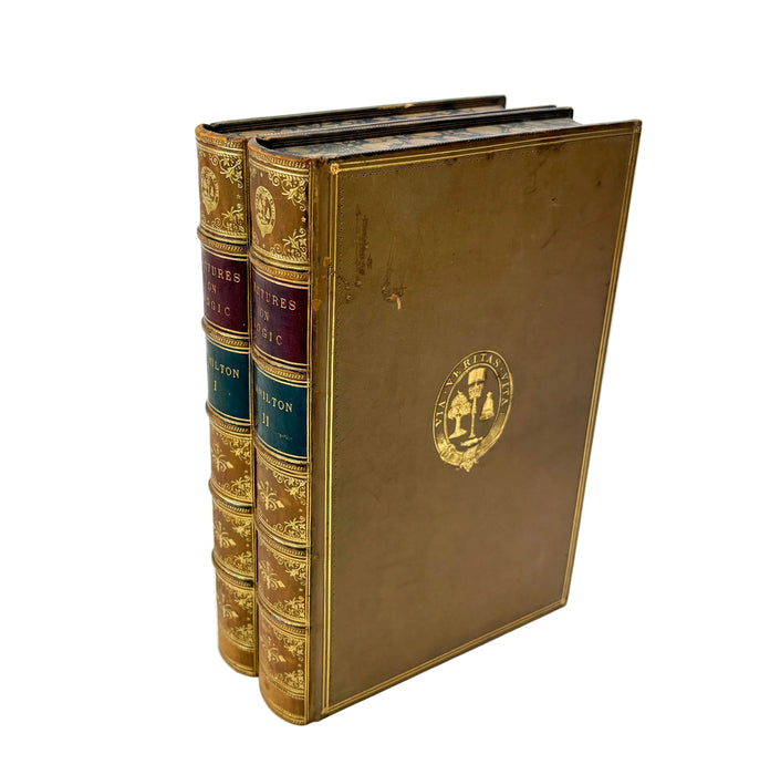 A vintage hardcover book set with gold-embossed leather binding and decorative title bands, standing upright on a white background.