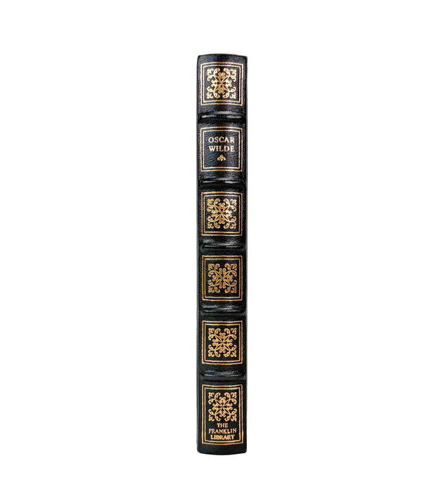 A single hardcover book standing upright on a white background, showing the full spine with ornate gold decorative panels and the title 'OSCAR WILDE' on the middle section.