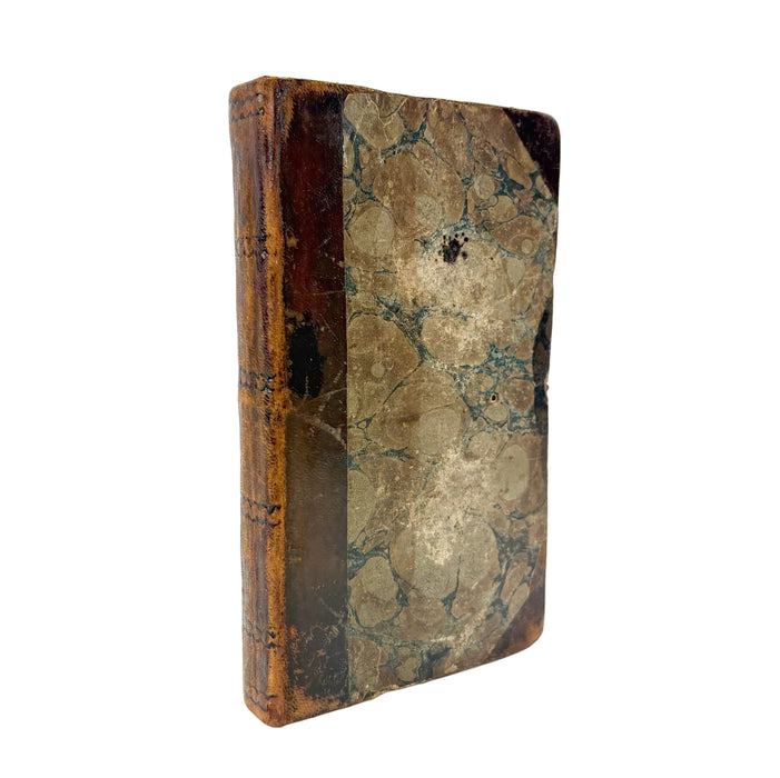 An antique hardcover book with a marbled brown and beige paper cover and a dark brown spine, photographed on a solid white background.