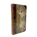 An antique hardcover book with a marbled brown and beige paper cover and a dark brown spine, photographed on a solid white background.
