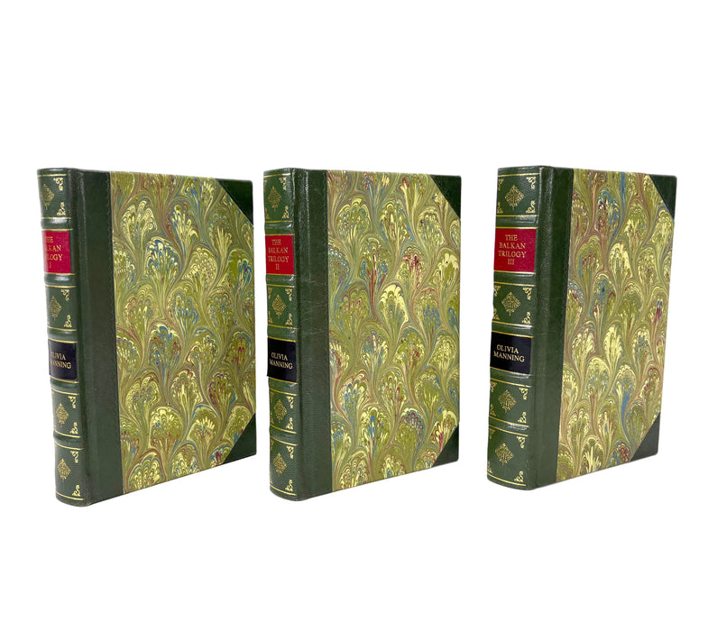 Three vintage hardcover books with green and gold marbled covers and red title bands, displayed upright on a white background.