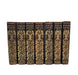 A set of seven hardcover books from 'Gibbons' Roman Empire Library' arranged in a row against a plain white background. The book spines are dark brown leather with ornate gold foil embossed patterns and lettering.