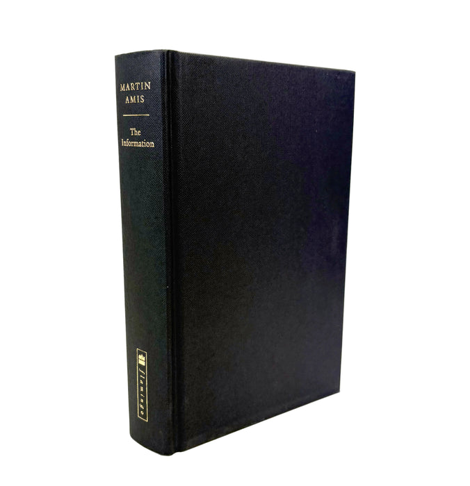 A black hardcover book standing upright at a slight angle, showing its spine and front cover. The spine is printed with gold text reading 'MARTIN AMIS' and 'The Information', with a small gold publisher mark near the bottom.