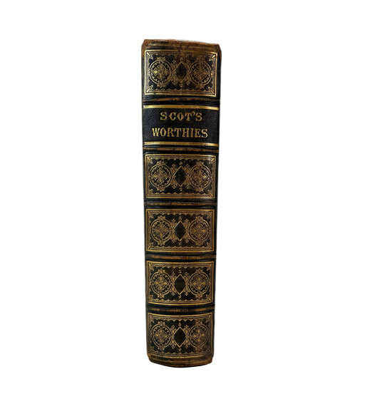 A vintage hardcover book spine titled 'SCOT'S WORTHIES' in gold lettering on a black leather binding with ornate gold gilding, photographed against a plain white background.