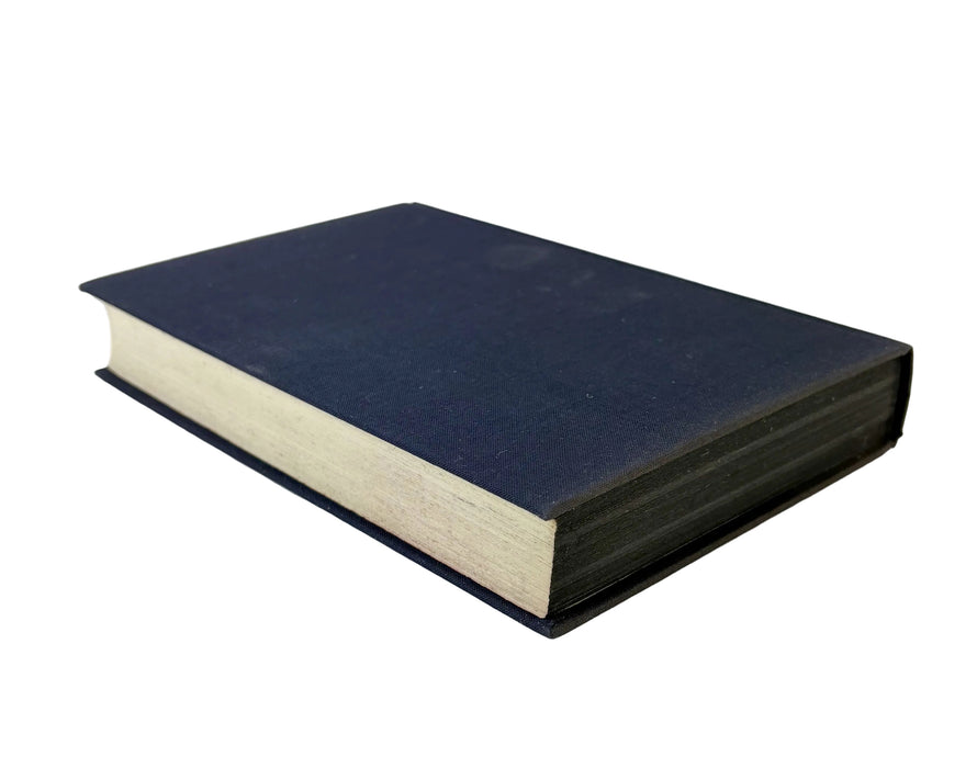 A hardcover book with a dark navy blue cover and thick off-white pages, photographed on a plain light background.