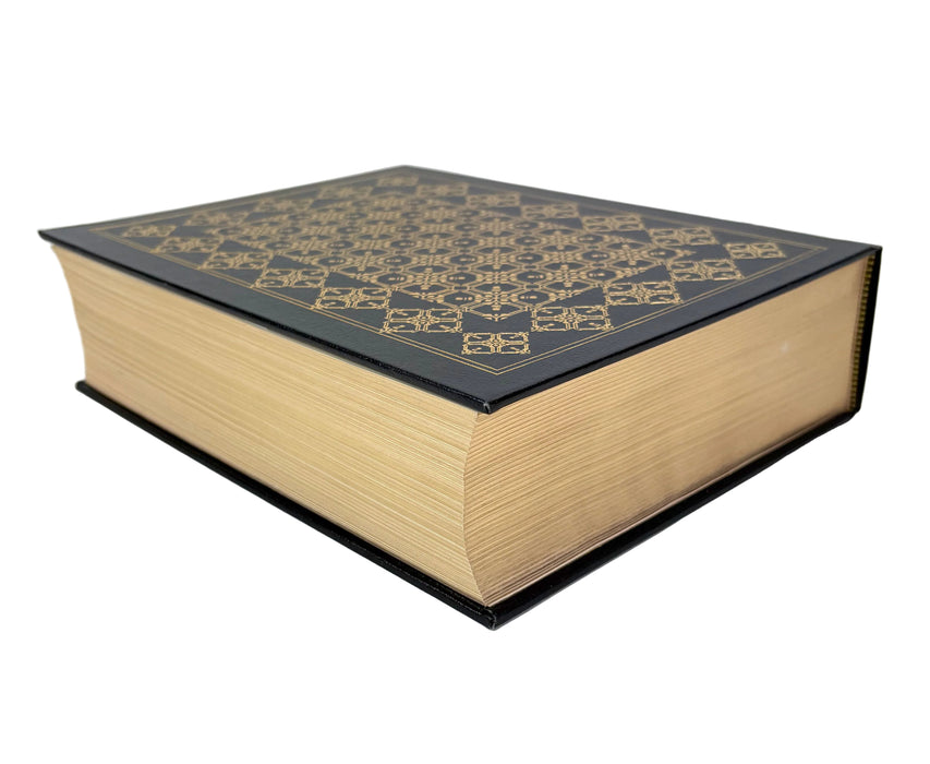 A hardcover book with a black cover featuring an intricate gold geometric pattern on the top, set against a plain white background.