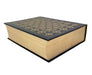 A hardcover book with a black cover featuring an intricate gold geometric pattern on the top, set against a plain white background.