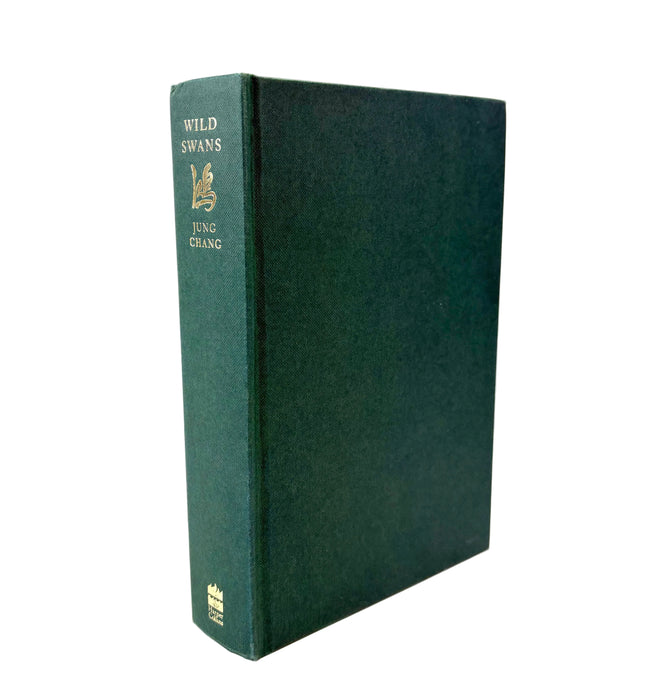 A hardcover book titled 'Wild Swans' by Jung Chang, featuring a dark green textured cloth binding with gold foil lettering on the spine, shown against a plain white background.
